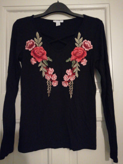 Black top with embroidered flowers