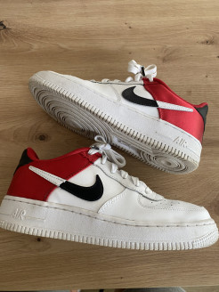Nike Air Force white sneakers with red and black details