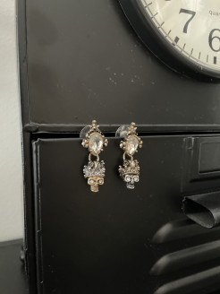 Two-tone skull earrings and crystal base with antique gold trim.