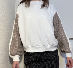 White jumper with pattern on sleeves