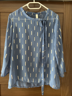 Transparent blue blouse with silver motifs