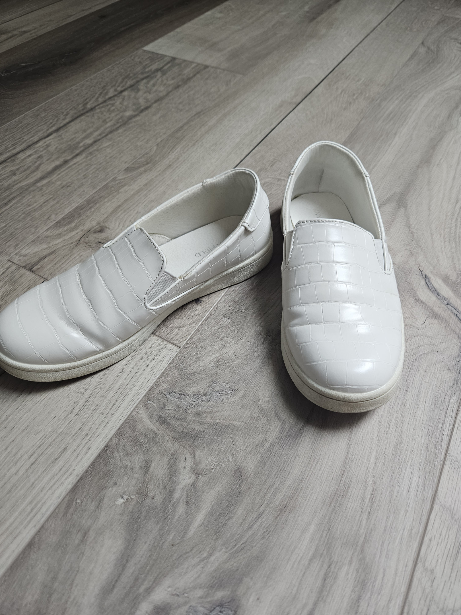 Small white laceless shoes