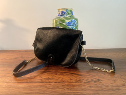 Beautiful black cowhide leather bag. Shoulder strap with metal ring.