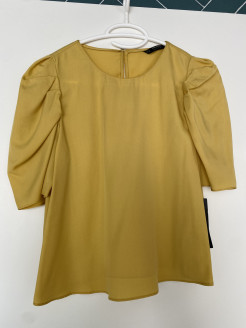 Elegant yellow blouse with puffed sleeves