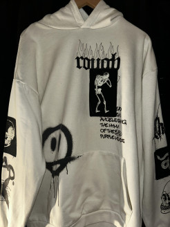 Off-white sweatshirt with black pattern/print.