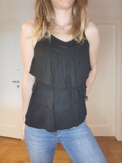 Black top with frills and pearls