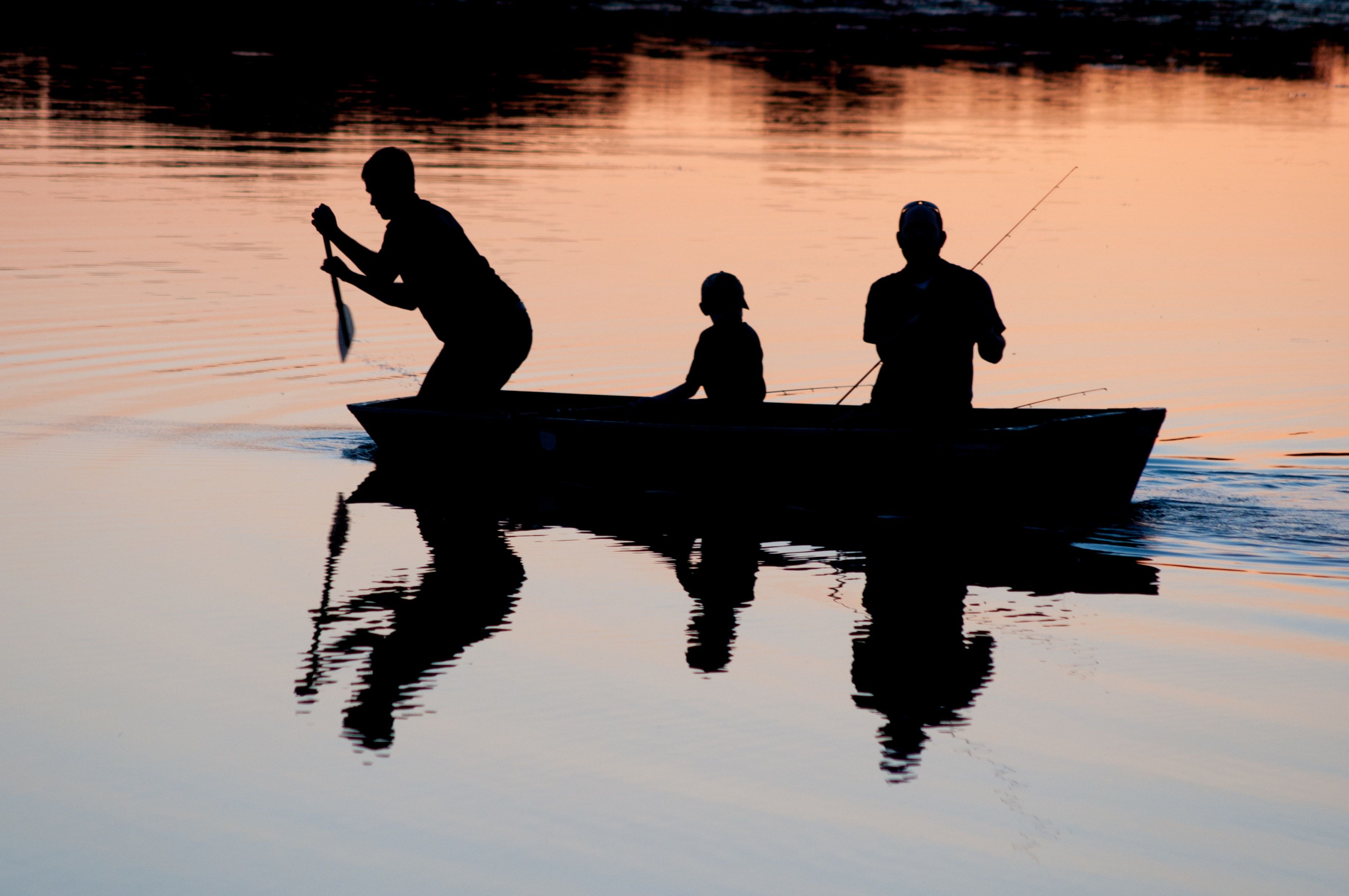 Personnes sur une barque en train de pêcher sur un lac